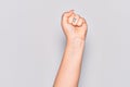 Hand of caucasian young woman doing protest and revolution gesture, fist expressing force and power