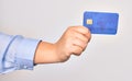 Hand of caucasian young woman holding credit card over isolated white background Royalty Free Stock Photo