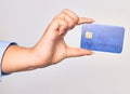 Hand of caucasian young woman holding credit card over isolated white background Royalty Free Stock Photo