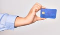 Hand of caucasian young woman holding credit card over isolated white background Royalty Free Stock Photo