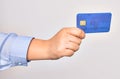 Hand of caucasian young woman holding credit card over isolated white background Royalty Free Stock Photo