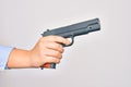 Hand of caucasian young woman holding gun over isolated white background Royalty Free Stock Photo