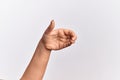 Hand of caucasian young woman holding invisible object, empty hand doing clipping and grabbing gesture Royalty Free Stock Photo