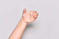 Hand of caucasian young woman holding invisible object, empty hand doing clipping and grabbing gesture Royalty Free Stock Photo