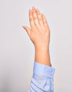 Hand of caucasian young woman showing number five with opened palm and streched fingers raised up over isolated white background Royalty Free Stock Photo