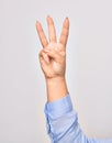 Hand of caucasian young woman showing number three with streched fingers raised up over isolated white background Royalty Free Stock Photo