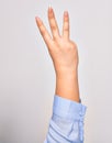 Hand of caucasian young woman showing number three with streched fingers raised up over isolated white background Royalty Free Stock Photo