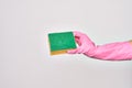 Hand of caucasian young woman wearing cleaning glove holding scourer sponge over isolated white background