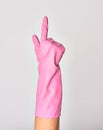 Hand of caucasian young woman wearing pink cleaning glove doing gun sign pointing with one finger over isolated white background Royalty Free Stock Photo