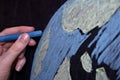 Hand with chalk drawing on the board of the planet earth Royalty Free Stock Photo