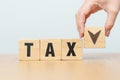 hand change wooden block with TAX text to UP and Down arrow icon. decrease and Increase, Taxpayer, Taxable Income, Tax Filing, Royalty Free Stock Photo