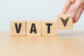 hand change wooden block with VAT text to UP and Down arrow icon. Value Added Tax, decrease and Increase, Taxpayer, Taxable Income Royalty Free Stock Photo