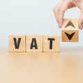 hand change wooden block with VAT text to UP and Down arrow icon. Value Added Tax, decrease and Increase, Taxpayer, Taxable Income Royalty Free Stock Photo