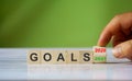 Hand changes the word `Goals 2020` to `Goals 2021