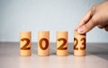 The hand changes the year from 2022 to 2023. New Year and Christmas holidays. Trends and changes, new challenges . Plans and goals