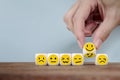 Hand Changing with smile emoticon icons face on Wooden Cube , hand flipping unhappy turning to happy symbol