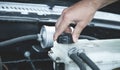 Hand checking level of coolant car engine