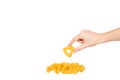 Hand with cheese puff sticks, crunchy corn snack, unhealthy food