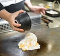 Hand of Chef cooking fried rice on hot pan in front of customers Royalty Free Stock Photo