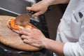 Hand of chef cutting pizza Royalty Free Stock Photo