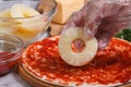 Hand chef puts pineapple rings on pizza Royalty Free Stock Photo