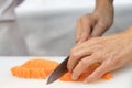 Hand of chef use knife preparing a fresh salmon on a cutting boa Royalty Free Stock Photo