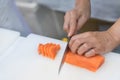 Hand of chef use knife preparing a fresh salmon on a cutting board, Japanese chef in restaurant slicing raw salmon, ingredient for Royalty Free Stock Photo