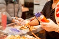 Hand of chef using burner cooking and burn King crab legs and giant prawns on stove to sale for customer