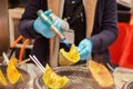 Hand of chef cooking and burn slice of cantaloupes and melons on stove Royalty Free Stock Photo