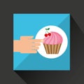 Hand with cherry fruit cupcake