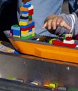 The hand of a child as he reaches for lego blocks