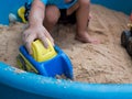 Hand of child boy playing car toy in sandbox outdoor. Royalty Free Stock Photo