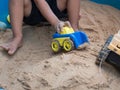 Hand of child boy playing car toy in sandbox outdoor. Royalty Free Stock Photo