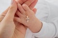 hand of a child with a cross, baptism of a child Royalty Free Stock Photo