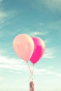 Hand of a child holding balloons, sky background Royalty Free Stock Photo