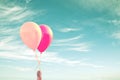 Hand of a child holding balloons sky background, vintage process Royalty Free Stock Photo