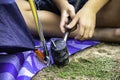 Hand of a child holding a rubber hammer Hammered steel mounting tent down on the ground