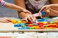 Hand child playing with construction blocks