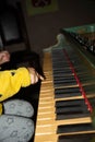 Hand of Child Playing Medieval Harpsichord in a Castle in Italy