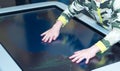 The hand of the child is pressing the touchscreen of the interactive table