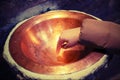 Hand of child touching the holy water in the stoup of the ancien Royalty Free Stock Photo