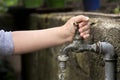 Hand from a child is turning tap water valve Royalty Free Stock Photo