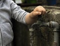 Hand from a child is turning tap water valve Royalty Free Stock Photo