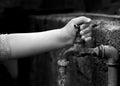 Hand from a child is turning tap water valve Royalty Free Stock Photo