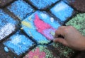 HAND of a child who draws with chalk on the road Royalty Free Stock Photo