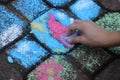 Hand of a child who draws with chalk on the road Royalty Free Stock Photo