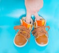Hand in children`s shoes as the man Royalty Free Stock Photo