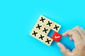 Hand choose check mark on cube wooden toy block stack with cross symbol for true or false changing mindset or way of adapting to Royalty Free Stock Photo