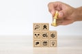 Hand choose cube wooden block stack with king chess on business strategy icon with graph and arrow bullseye of strategic plan Royalty Free Stock Photo