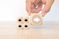 Hand chooses arrow icon point to the opposite side on cube wooden block stack pyramid concept of adaptation challenge change Royalty Free Stock Photo